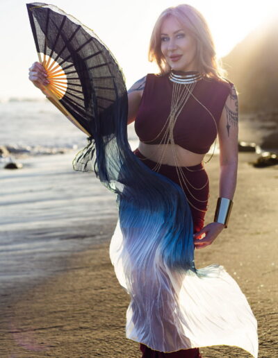 Violet Jolie tantric massage Newport Beach gold headpiece fan sunset