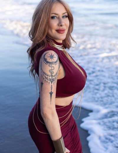 Violet Jolie tantric massage Newport Beach burgundy dress ocean background